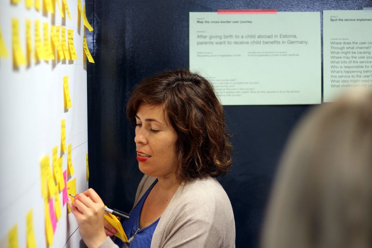 Vicky Teinaki writing on a whiteboard